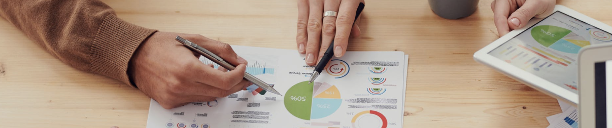 team discussing results depicted on pie chart